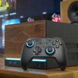 A DIY PC sits on a desk with wood paneling.