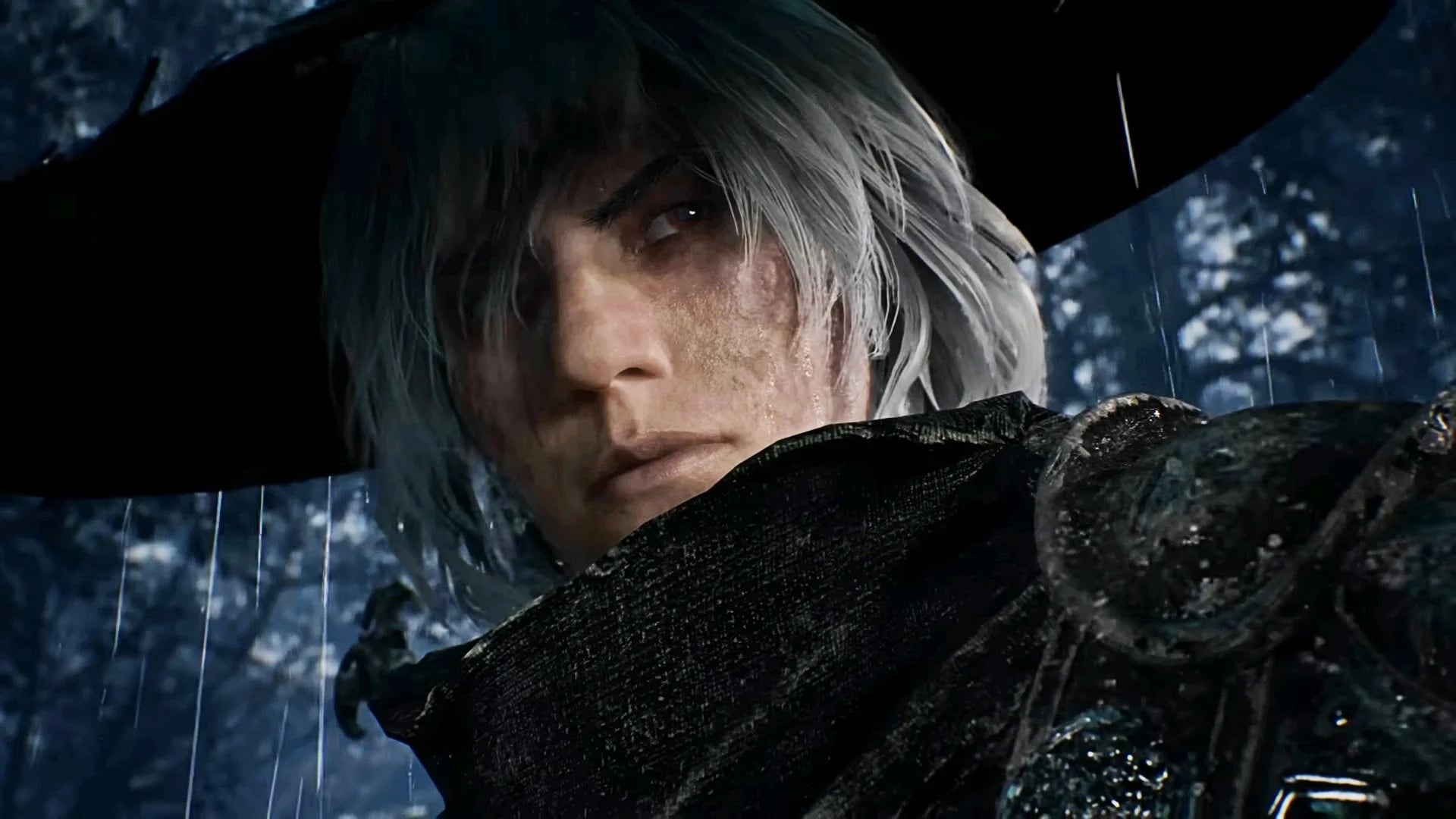 A man wears a hat in the rain.