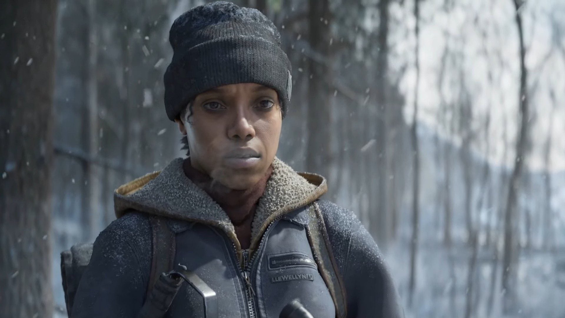 A woman stands in the cold hunting a deer.